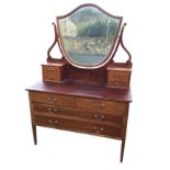An Edwardian mahogany satinwood crossbanded dressing table, the back with large bevelled shield