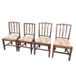 A set of four nineteenth century elm dining chairs with dowel jointed stepped back rails above