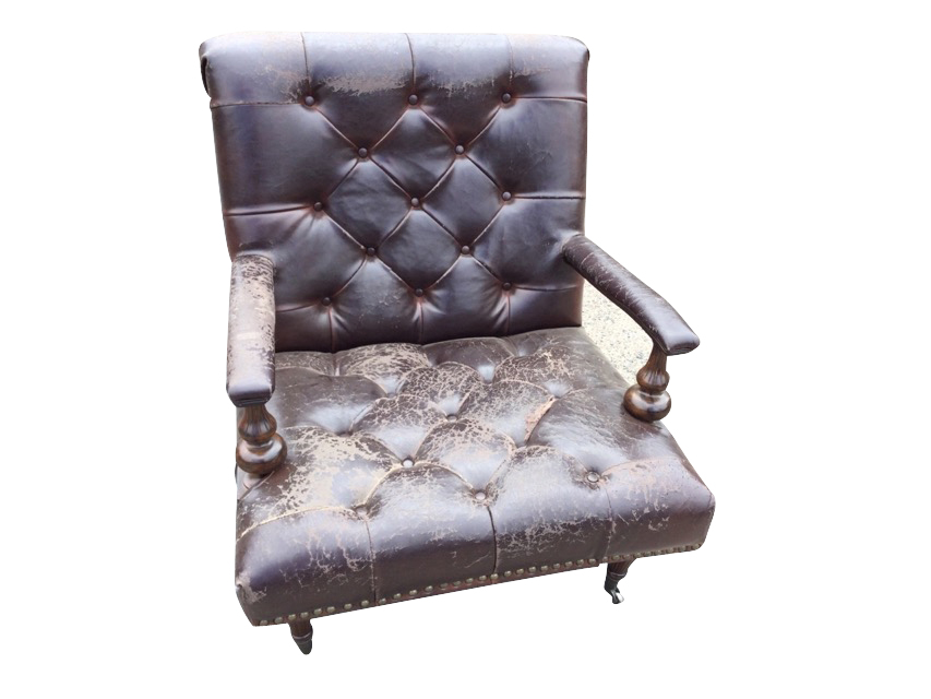 A leather button upholstered armchair, the wide brass studded seat having armrests on fluted