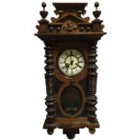 A Victorian walnut Vienna wallclock with Gustav Becker movement, the crest surmounted by an eagle