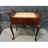 A stained C20th rectangular piano stool having upholstered box seat flanked by turned handles,