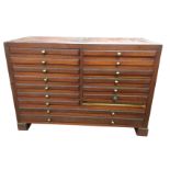 A mahogany collectors cabinet with sixteen brass knobbed drawers raised on block feet - one drawer