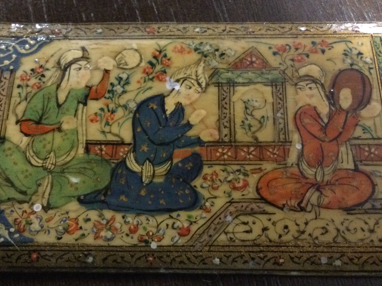 A Persian ivory panel, dated to verso Tehran 1945 with inscription, painted with three seated - Image 3 of 3