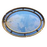 A nineteenth century oval mirror in gadrooned gilt & gesso frame, having inner border with applied