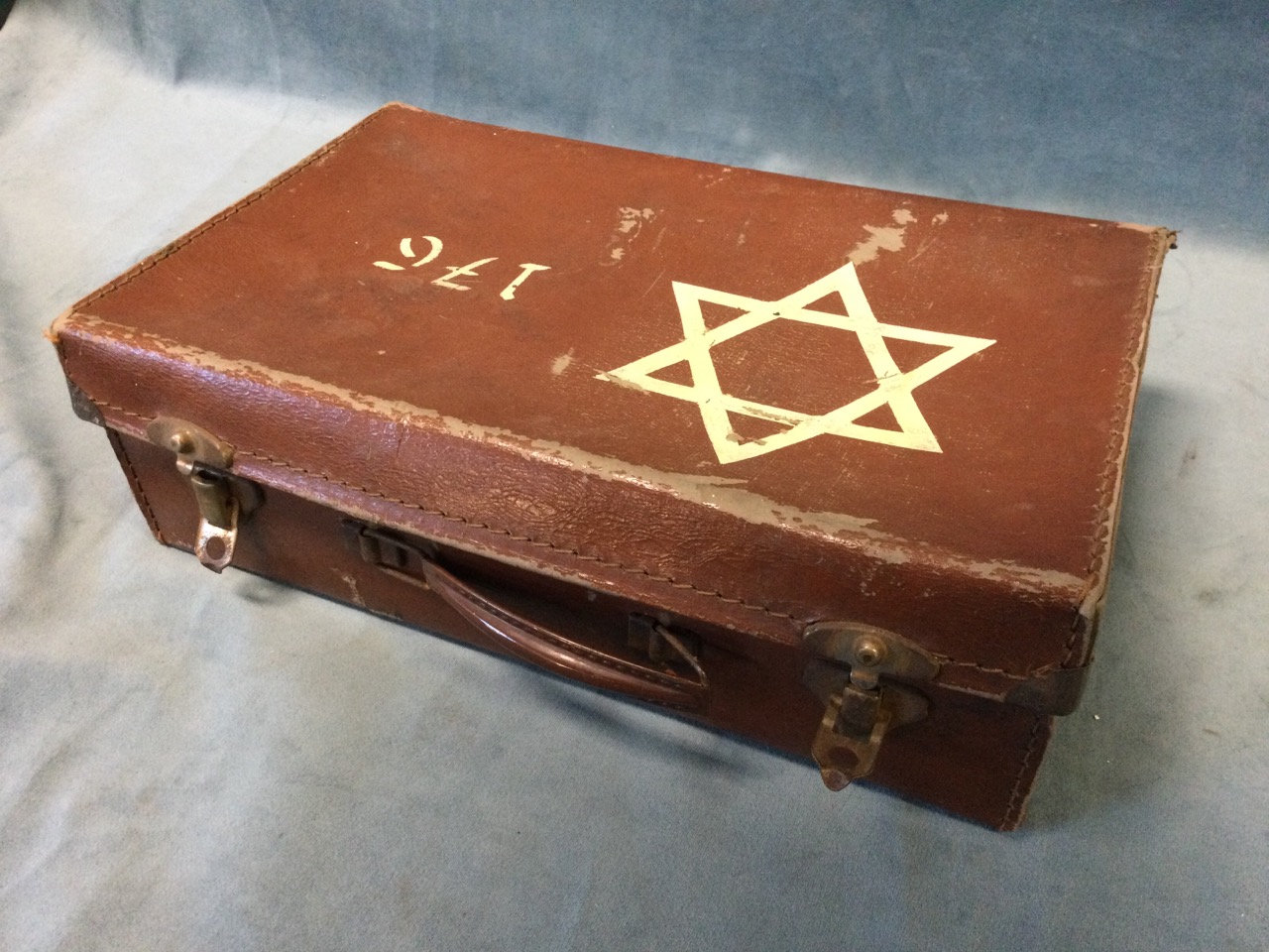 A Second World War suitcase painted with Star of David insignia, containing a quantity of German