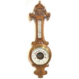 A Victorian carved oak barometer having dial with retail name of Wilson & Gillie of North Shields,