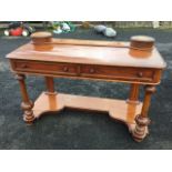 A Victorian mahogany dressing table with two circular lidded compartments on rectangular moulded