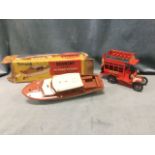 A boxed Lines Bros Tri-ang 14in electric cabin cruiser; and a tinplate toy omnibus with hinged upper