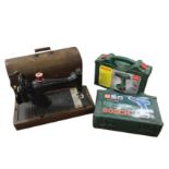 Two cased Bosch electric drills; and a C20th oak cased Singer sewing machine. (3)