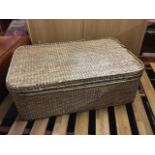 A rectangular 4ft cane coffee table basket by Oka, with rounded corners and interior tray. (48in x