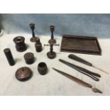A small collection of ebony - turned pots & covers, a tray, a pair of candlesticks, glove