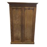 A late Victorian mahogany arts and crafts style wardrobe, with moulded cornice above panelled