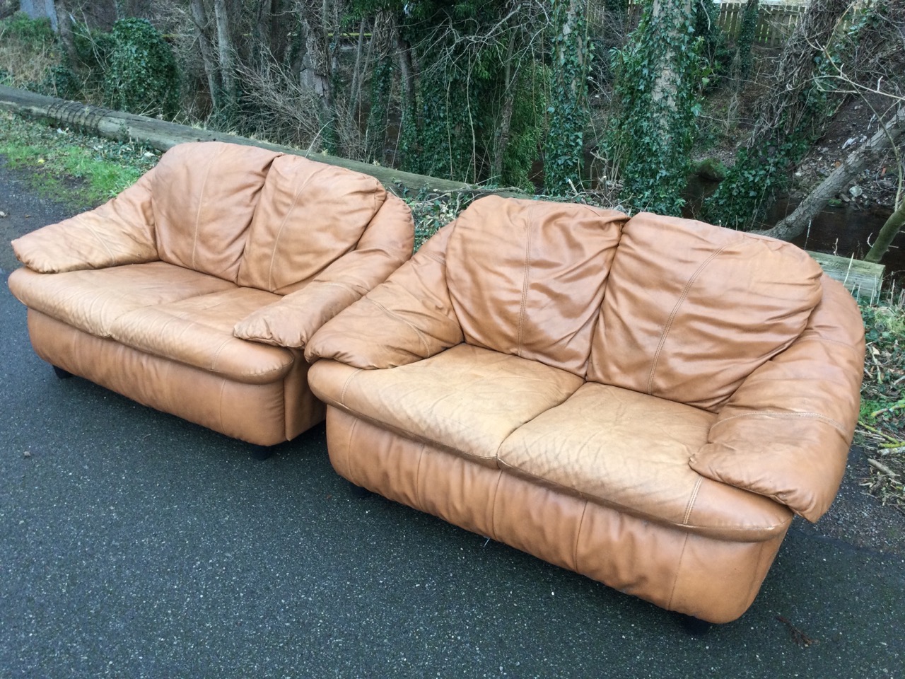 A pair of two-seater leather sofas with integral back, seat and armrest cushions, raised on - Image 2 of 3