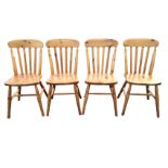 A set of four pine slatback kitchen chairs with solid seats raised on turned legs & stretchers. (4)