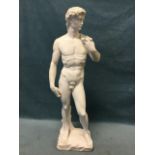 A painted composition stone statue of David, standing on rectangular naturalistically moulded plinth