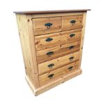 A reproduction pine chest of two short and four long drawers, having fielded panels and twisted ring