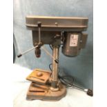 A geared bench drill on stand with adjustable platform. (23.5in)