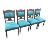 A set of four late Victorian mahogany dining chairs, the upholstered back panels framed by reeded