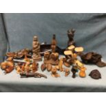 A collection of carved wood items including tribal type pieces, mushrooms & toadstools, carved