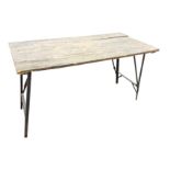 A rectangular folding table with four plank top on locking angled metal legs. (54in x 26in x 29.