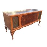 A burr walnut cased Dynatron radiogram record player, the crossbanded cabinet enclosing a Garrard