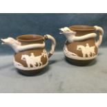 A graduated pair of Brameld Rockingham chrysanthemum ware jugs with entwined serpent handles and