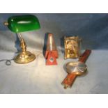 An Edwardian style brass desk lamp with circular moulded base and adjustable green glass shade; a