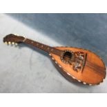 A nineteenth century Italian mandolin with bulbous rosewood body inlaid with boxwood stringing,