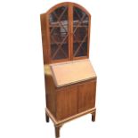 A mahogany bureau bookcase, the arched top above astragal glazed doors enclosing adjustable shelves,