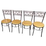 A set of four black painted metal kitchen chairs with circular hardwood seats on tubular legs joined