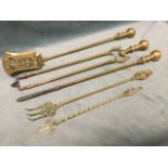 A set of brass fire irons - a shovel, tongs and poker with turned ball finial handles; and two brass
