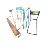 Miscellaneous garden tools including a push-along cylinder handmower (new?), hoes, a fork, an