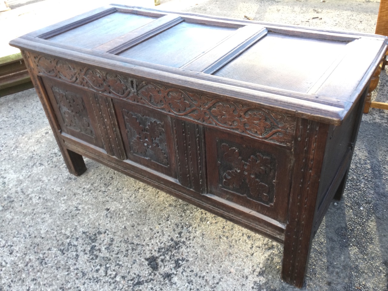 A nineteenth century carved oak coffer with three moulded panels to hinged top, the front with blind - Image 3 of 3