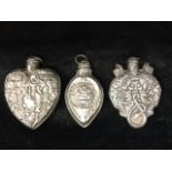 A heart shaped Victorian style silver scent bottle with screw stopper, embossed with scrolled