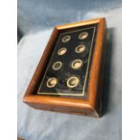 An Edwardian servants bell panel in cushion moulded frame around a glass with eight circular