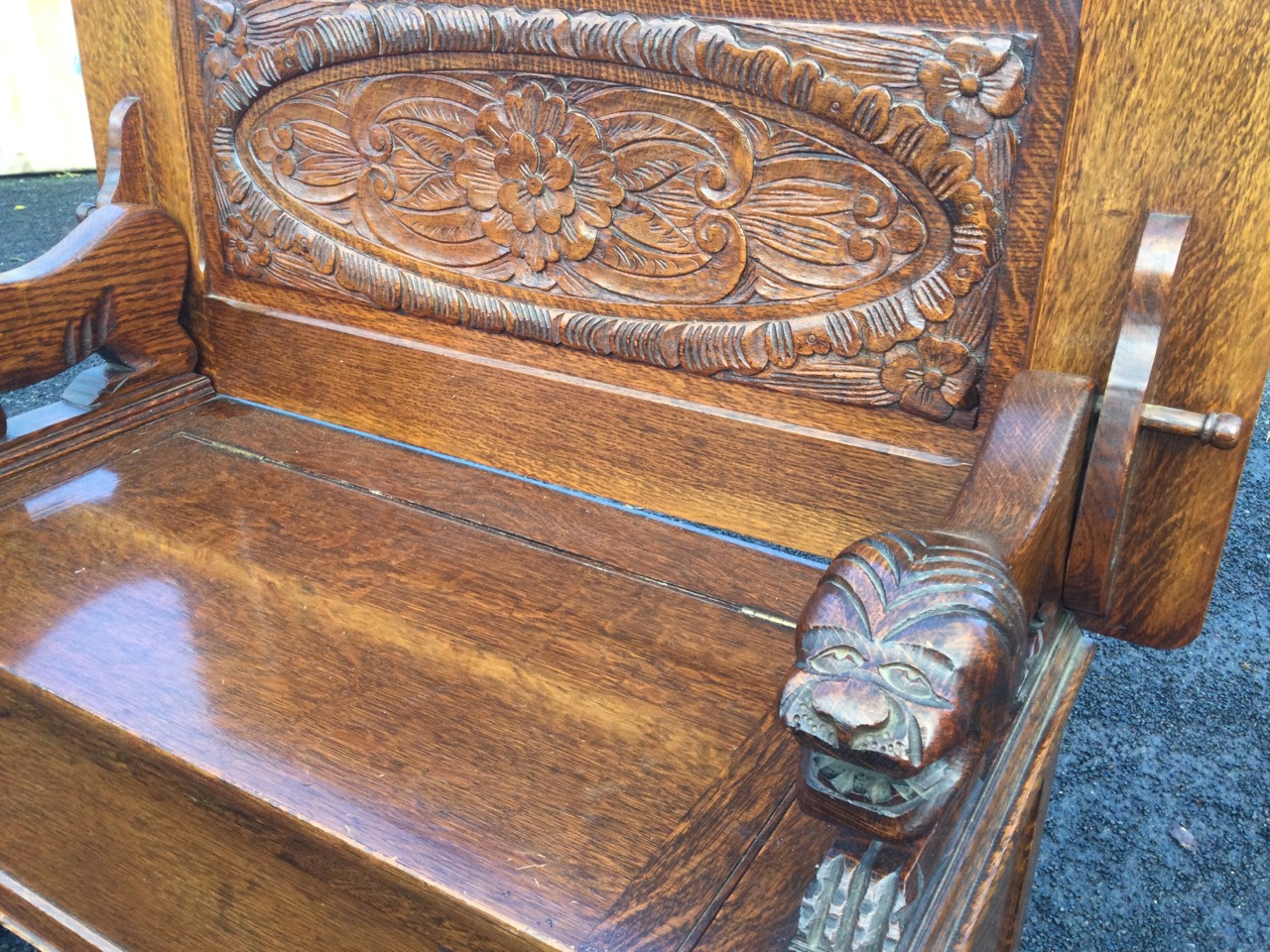 An oak monks bench with fielded panelled tabletop supported by carved lions revealing an oval floral - Image 3 of 3