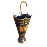 A tapering tin stickstand in the form of an umbrella with foliate gilt decoration, having central