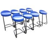 A set of eight bar stools with circular plastic seats on tubular cantilevered supports with foot