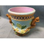 A Victorian majolica jardiniere embossed with oak leaves and acorns on pale blue ground, having