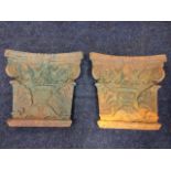 A pair of cast iron tapering capital panels, embossed with foliate scrolled anthemion decoration