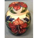 A tube-lined Moorcroft ginger jar & cover decorated with honeysuckle type flowers and leaves -
