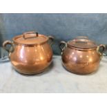 A graduated pair of antique pot-bellied copper pots & covers riveted with tapering iron handles, the