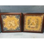 A pair of regency style embroidered textile panels, depicting musical instruments framed by
