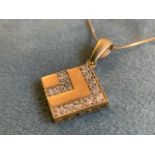 A diamond pendant, the fourteen stones set on a 9ct gold square panel, hung on a fine gold chain. (