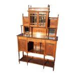 A late Victorian walnut dresser with fine fretwork gothic gallery surmounted by urn finials above