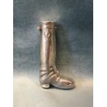 A sterling silver vesta modelled as a riding boot, with hinged lid and striking groove to sole. (2.