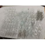 A large quantity of drinking glasses, mainly in sets including wine glasses, brandy balloons,