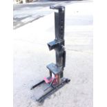 A gas powered log splitter with adjustable column on trolley stand.