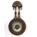 A late Victorian carved mahogany framed hanging aneroid barometer with circular dial under