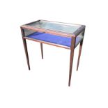 A rectangular stained mahogany bijouterie table with locking glass case having moulded glazed lid,